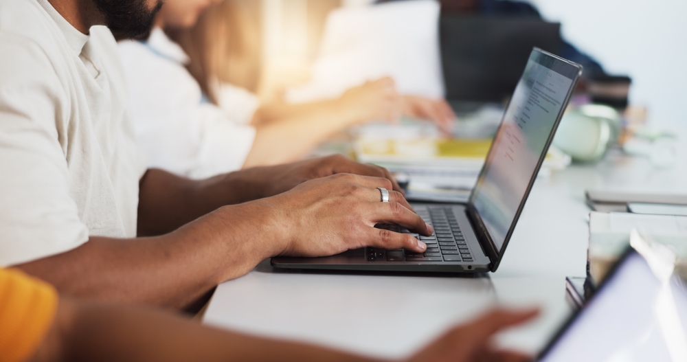 hands,,person,and,student,with,laptop,in,classroom,for,education,